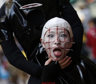 A participant in costume poses before a Halloween parade in Kawasaki