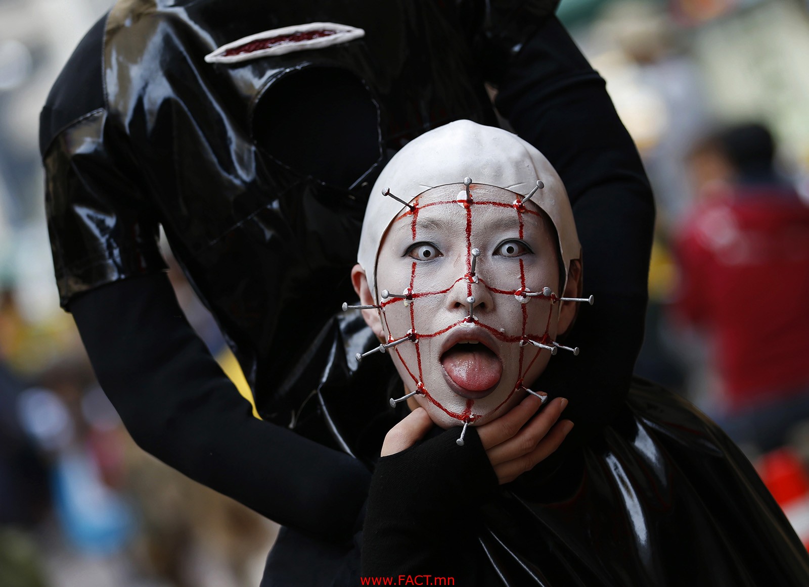 A participant in costume poses before a Halloween parade in Kawasaki