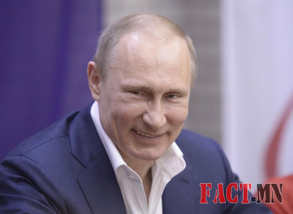 Russian President Vladimir Putin smiles as he celebrates International Women's Day in Sochi