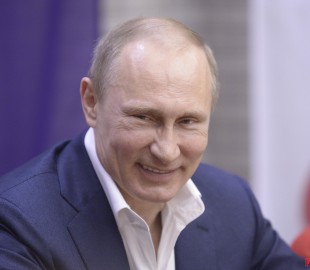 Russian President Vladimir Putin smiles as he celebrates International Women's Day in Sochi