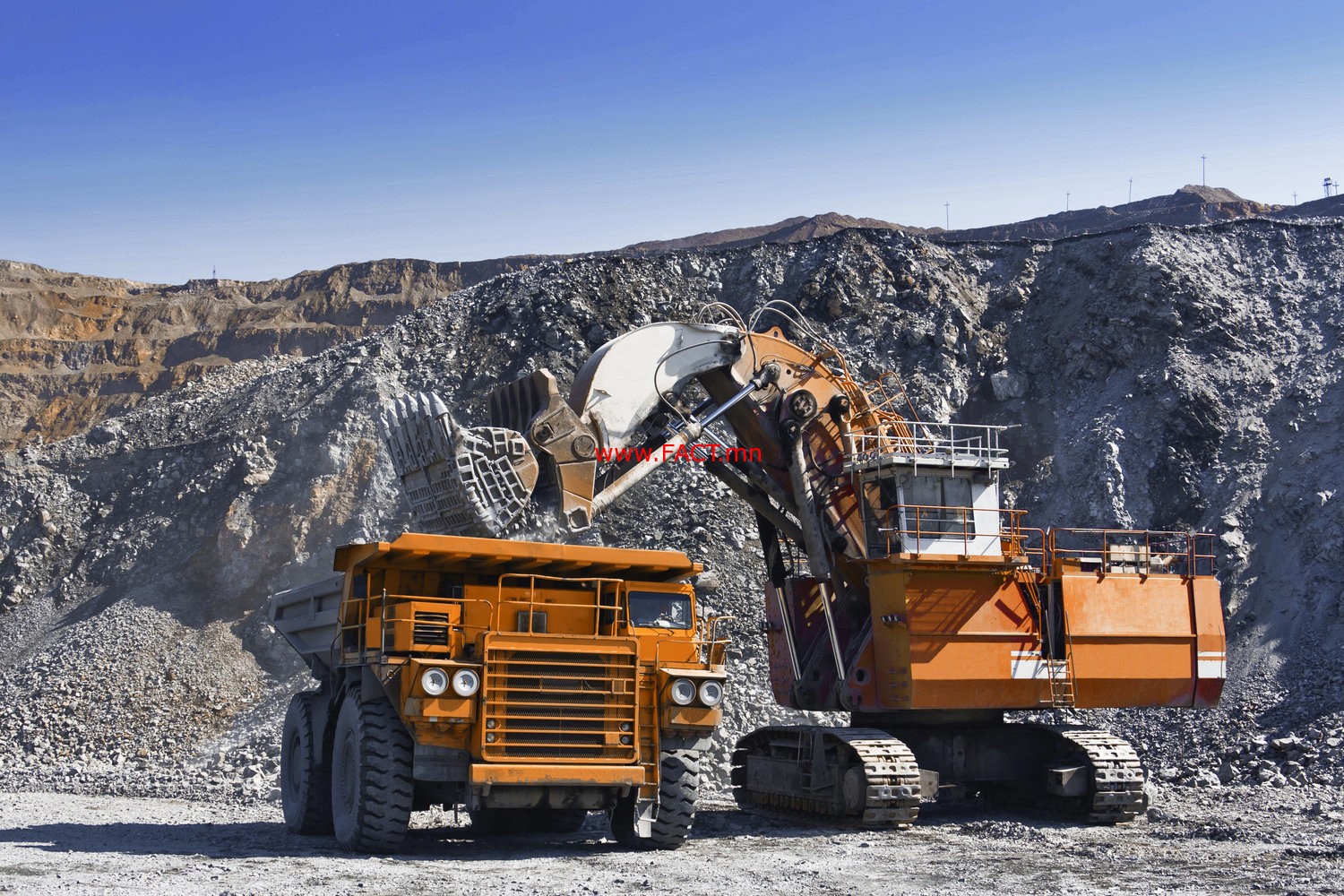 Loading the gold ore into heavy dump truck at the opencast mining