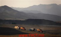Coal trucks drive along a road leading to a mine located on the outskirts of the city of Baotou, in China's Inner Mongolia Autonomous Region