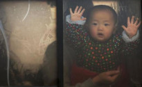 A baby looks through the window of a vehicle stranded on a highway between Beijing and Hebei province, China, that is closed due to smog on an extremely polluted day