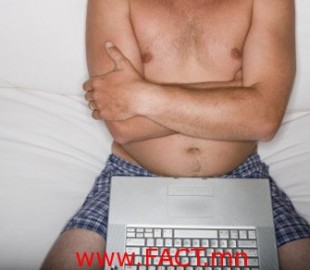man in his underwear using a laptop on the couch