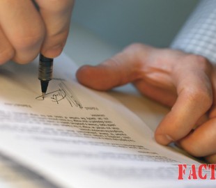 Man's Hands Signing Document