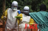 Medical staff working with Medecins sans Frontieres prepare to bring food to patients kept in an isolation area at the MSF Ebola treatment centre in Kailahun